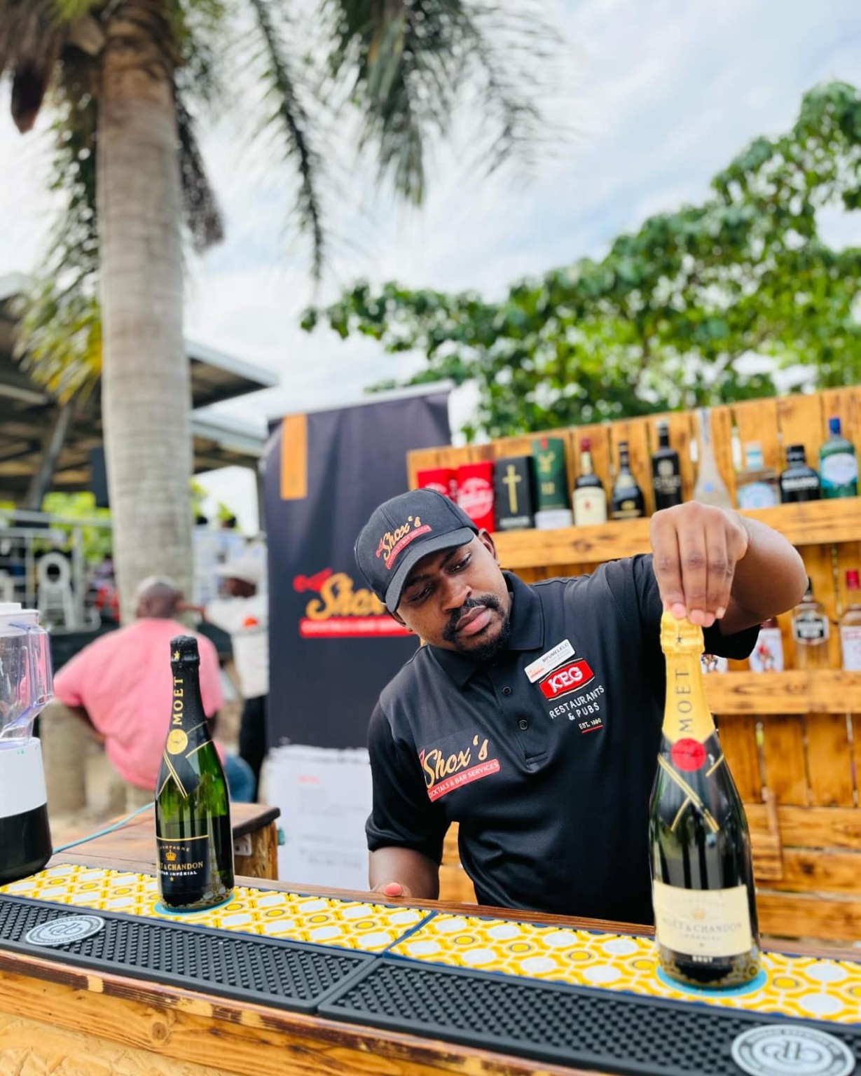 Bartender serving champagne at a Shox's bar
